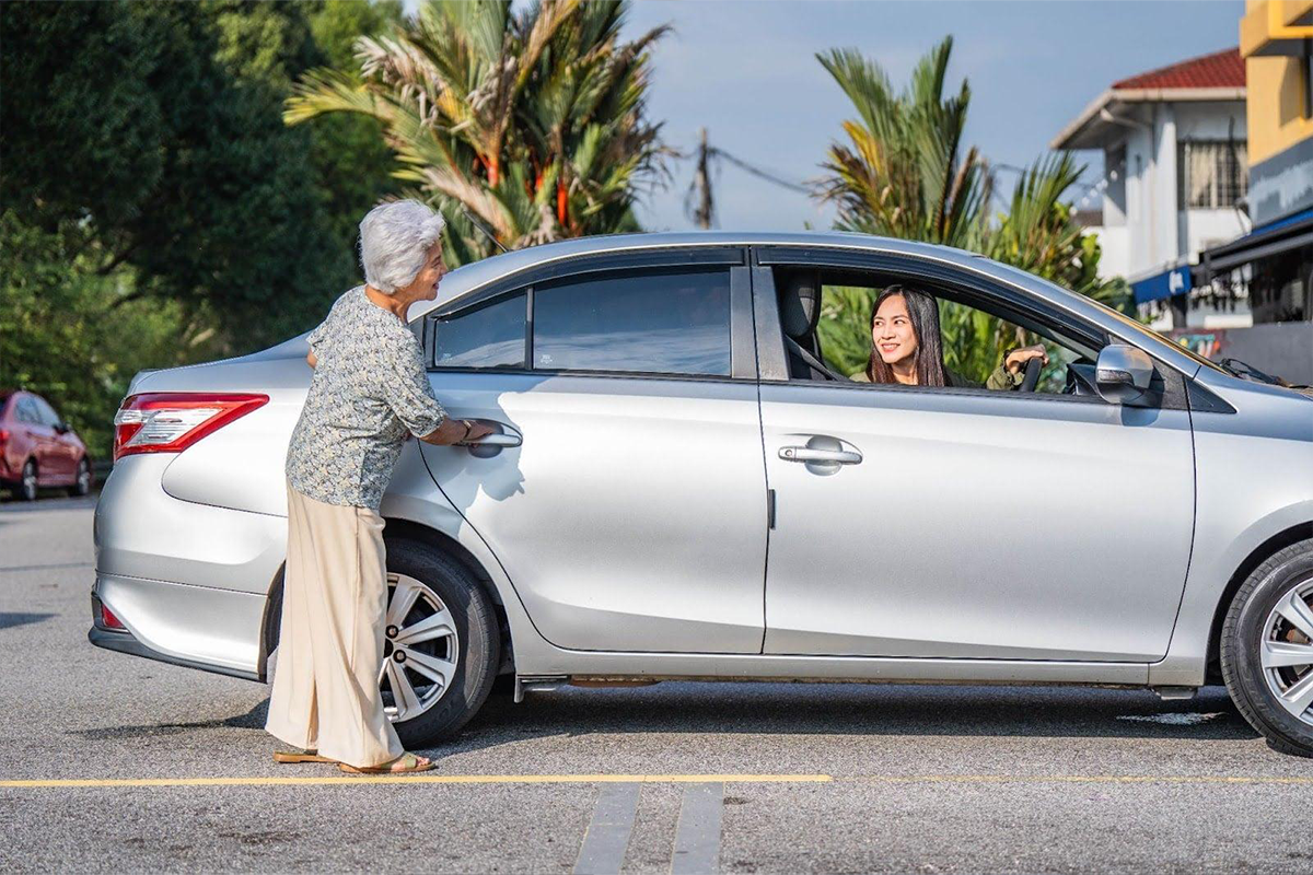 Passenger entering a Grab car